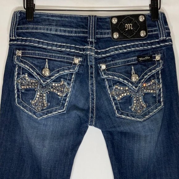 designer jeans with cross on back pocket